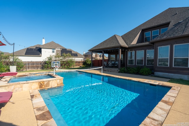 view of pool with an in ground hot tub and a patio