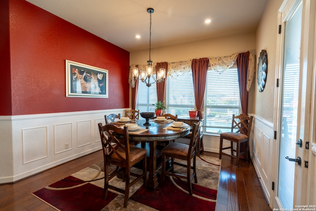 dining space with an inviting chandelier and dark hardwood / wood-style floors