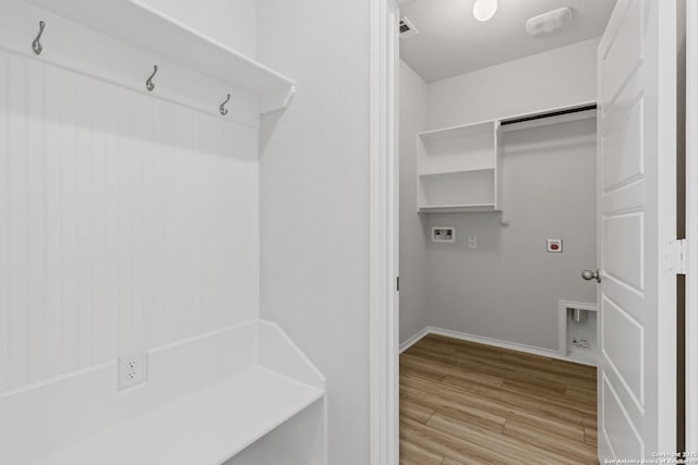 washroom with laundry area, hookup for a gas dryer, washer hookup, light wood finished floors, and baseboards