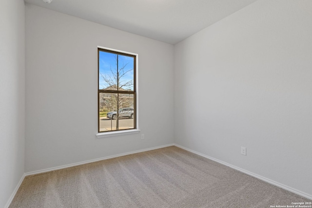 carpeted empty room with baseboards