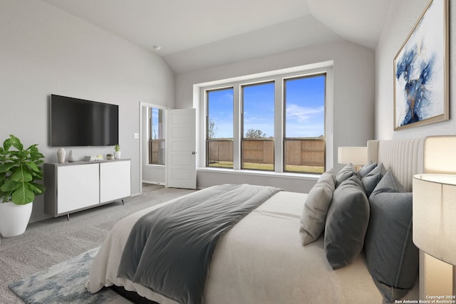 bedroom with carpet flooring and lofted ceiling
