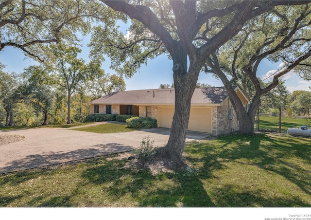 ranch-style home with a front yard and a garage