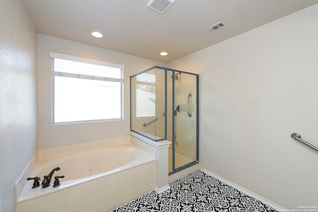 bathroom featuring tile patterned floors and separate shower and tub