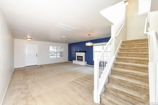 stairway featuring carpet flooring