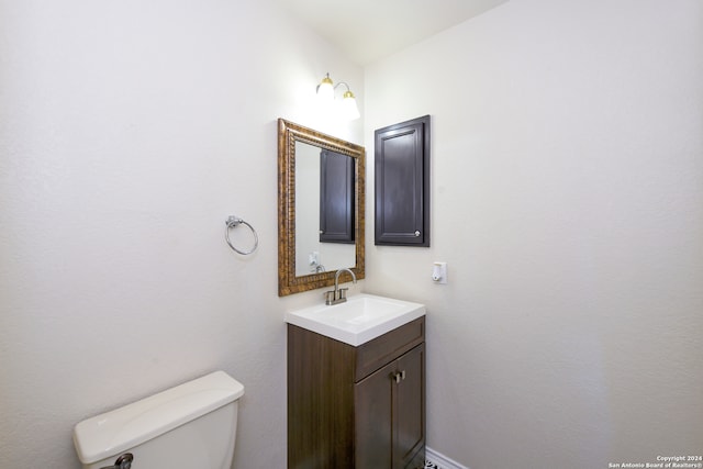 bathroom with toilet and vanity