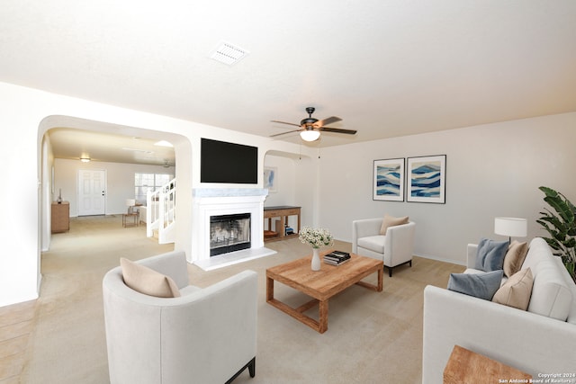 living room featuring light carpet and ceiling fan