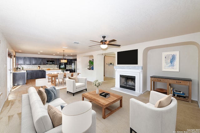 living room with ceiling fan and light tile patterned floors