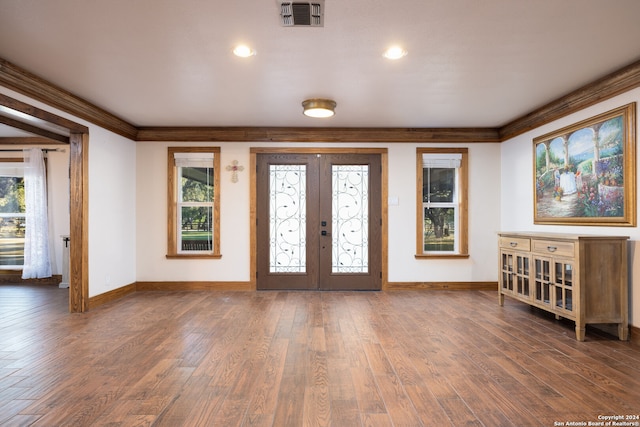 foyer featuring french doors, ornamental molding, and dark hardwood / wood-style floors