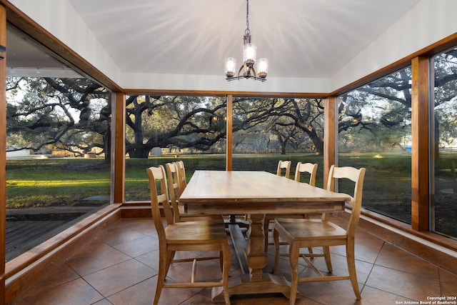 sunroom with vaulted ceiling and an inviting chandelier