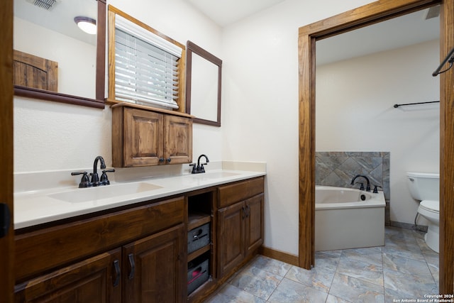 bathroom featuring vanity, toilet, and a bathing tub