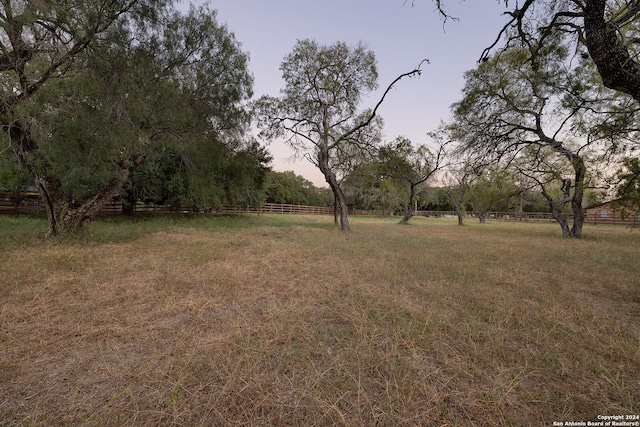 yard at dusk with a rural view