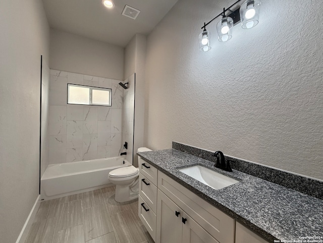 full bathroom featuring toilet, vanity, and tiled shower / bath combo