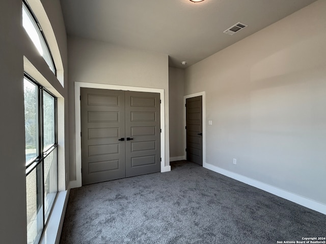 unfurnished bedroom with carpet floors and a closet