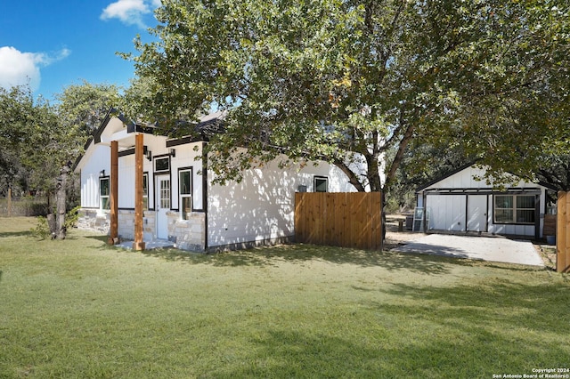23238 Copper Canyon Dr, Elmendorf, TX 78112 - exterior space featuring fence, a lawn, and stone siding