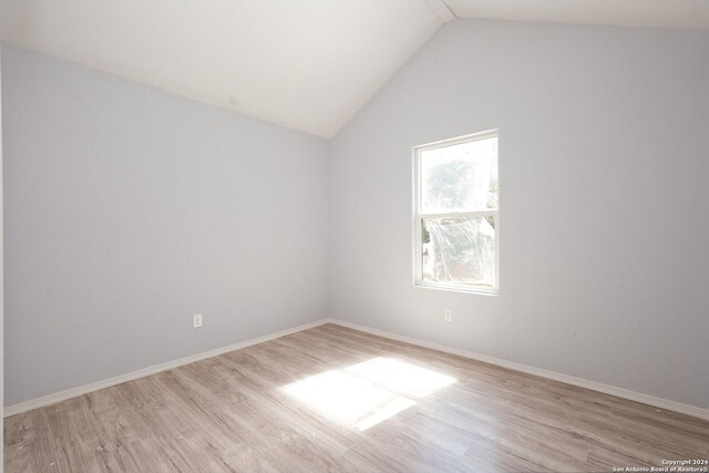 23238 Copper Canyon Dr, Elmendorf, TX 78112 - unfurnished room featuring baseboards, vaulted ceiling, and wood finished floors