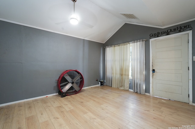 empty room with light hardwood / wood-style floors, lofted ceiling, ornamental molding, and ceiling fan