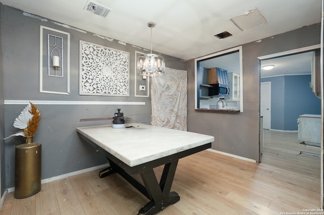 interior space with a notable chandelier and light wood-type flooring