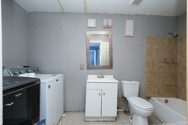 full bathroom featuring toilet, tile patterned flooring, vanity, washtub / shower combination, and washing machine and clothes dryer