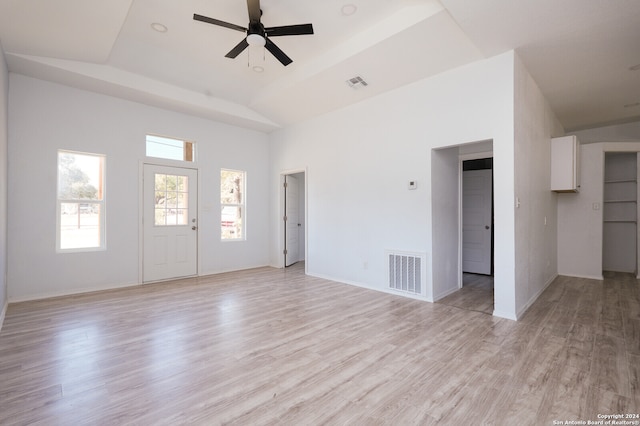 unfurnished living room featuring light hardwood / wood-style floors, lofted ceiling, and ceiling fan