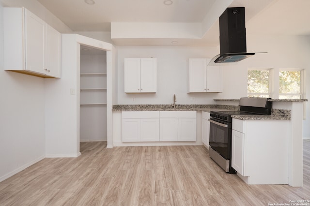 kitchen featuring light hardwood / wood-style flooring, white cabinets, stainless steel electric range oven, and range hood