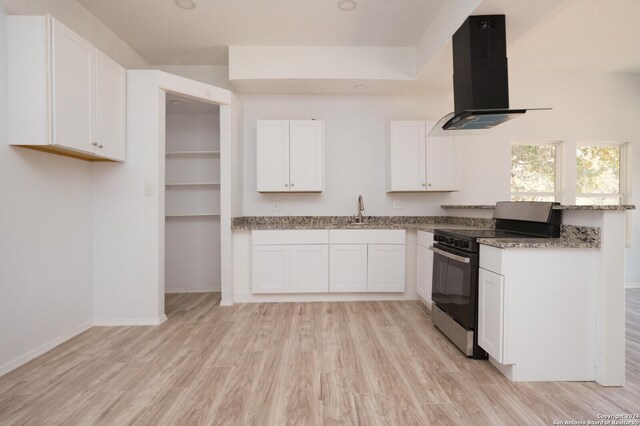 23238 Copper Canyon Dr, Elmendorf, TX 78112 - kitchen with stainless steel range with electric stovetop, light wood-style flooring, white cabinetry, and exhaust hood