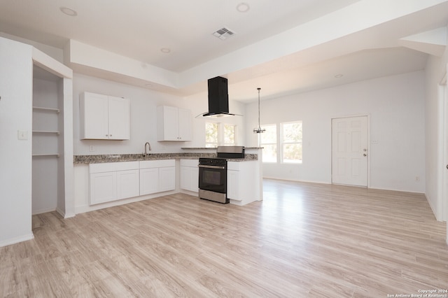 kitchen with range hood, white cabinets, light hardwood / wood-style flooring, and stainless steel stove