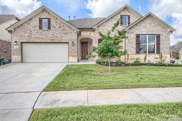 view of front of home featuring a garage and a front lawn