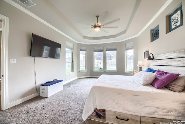 bedroom featuring ceiling fan, crown molding, carpet floors, and a raised ceiling