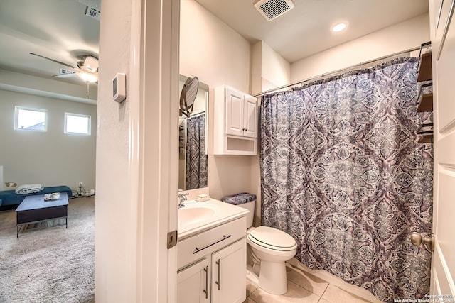 bathroom with toilet, tile patterned flooring, a shower with curtain, vanity, and ceiling fan