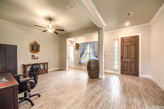 office space featuring crown molding, light hardwood / wood-style flooring, and ceiling fan