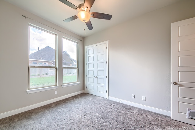 unfurnished bedroom with carpet floors, a closet, and ceiling fan