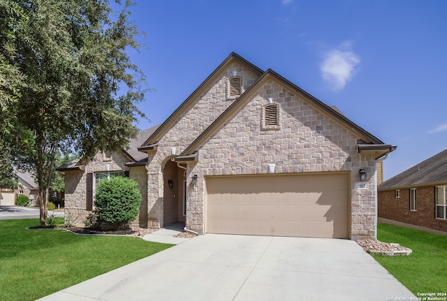 view of front of house with a front yard and a garage