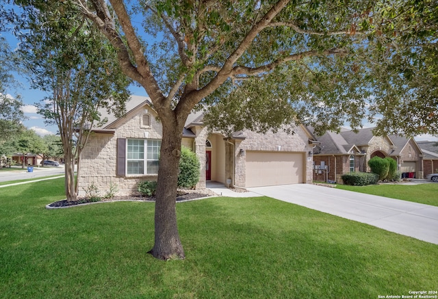 view of front of house with a front yard and a garage