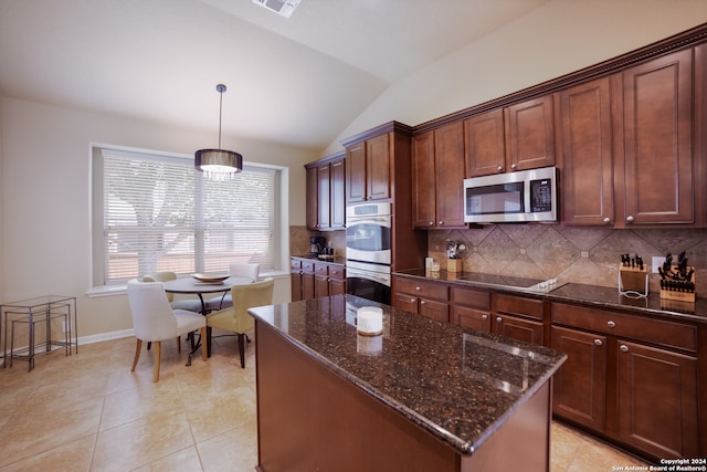 kitchen featuring tasteful backsplash, a center island, stainless steel appliances, vaulted ceiling, and pendant lighting