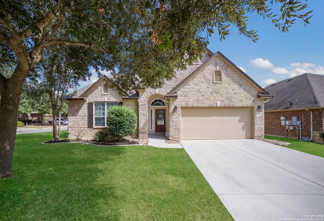 view of front of property with a front yard and a garage