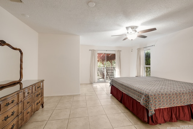 bedroom featuring a textured ceiling, access to exterior, light tile patterned floors, and ceiling fan