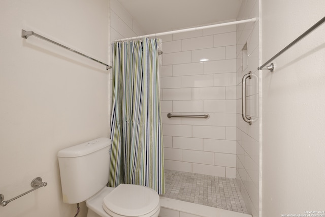 bathroom with a shower with shower curtain and toilet