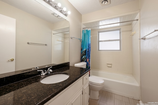 full bathroom with vanity, a textured ceiling, toilet, and shower / bathtub combination with curtain