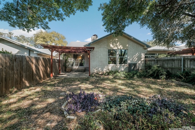 back of house featuring a patio and a pergola