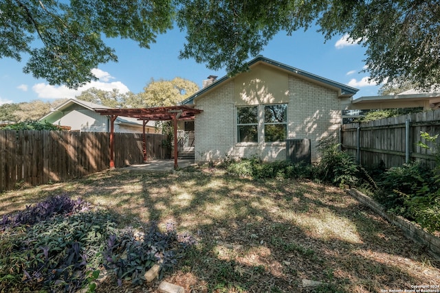 rear view of house featuring a pergola