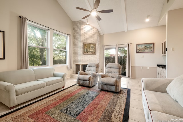 living room featuring a brick fireplace, ceiling fan, high vaulted ceiling, and light tile patterned floors