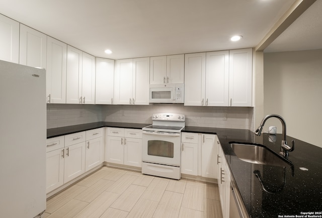 kitchen featuring white cabinetry, tasteful backsplash, sink, and white appliances