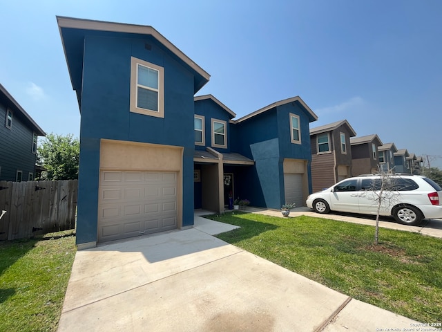 view of front of home with a front yard and a garage