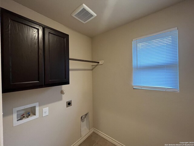 6614 Mia Way, San Antonio, TX 78233 - clothes washing area featuring hookup for an electric dryer, hookup for a washing machine, cabinet space, baseboards, and tile patterned flooring
