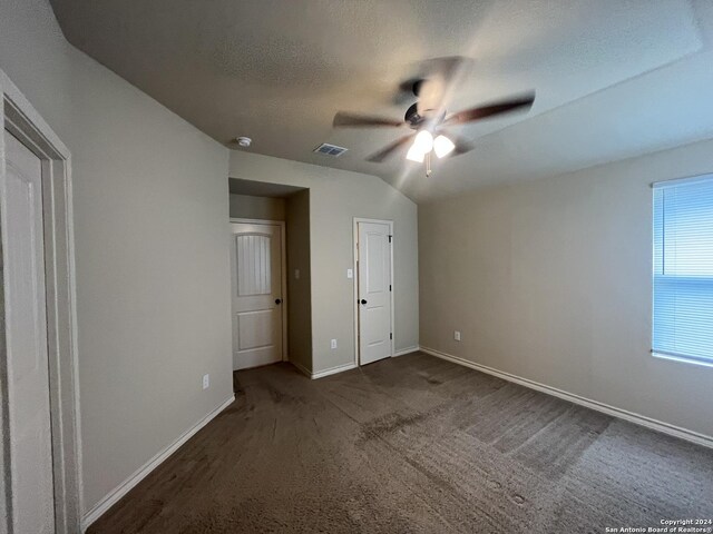 6614 Mia Way, San Antonio, TX 78233 - unfurnished bedroom featuring baseboards, dark colored carpet, ceiling fan, and lofted ceiling