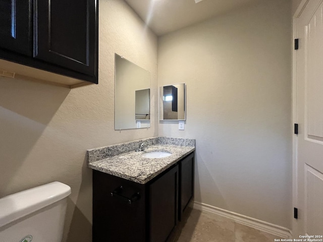 6614 Mia Way, San Antonio, TX 78233 - bathroom featuring vanity, toilet, baseboards, and tile patterned floors