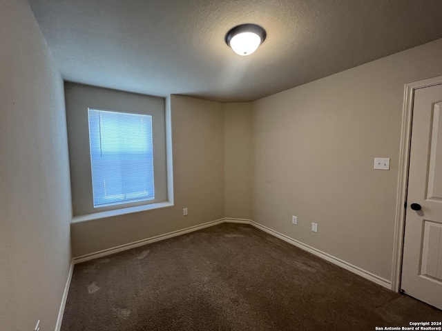 6614 Mia Way, San Antonio, TX 78233 - spare room featuring dark carpet and baseboards