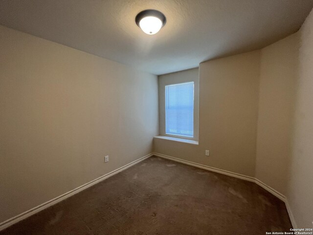 6614 Mia Way, San Antonio, TX 78233 - empty room with dark carpet and baseboards