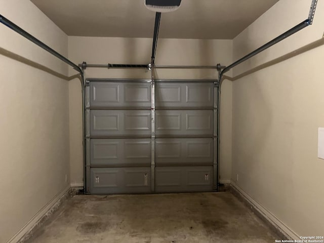 6614 Mia Way, San Antonio, TX 78233 - garage featuring baseboards and a garage door opener