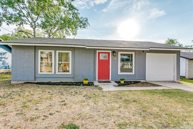 ranch-style home with a front yard and a garage